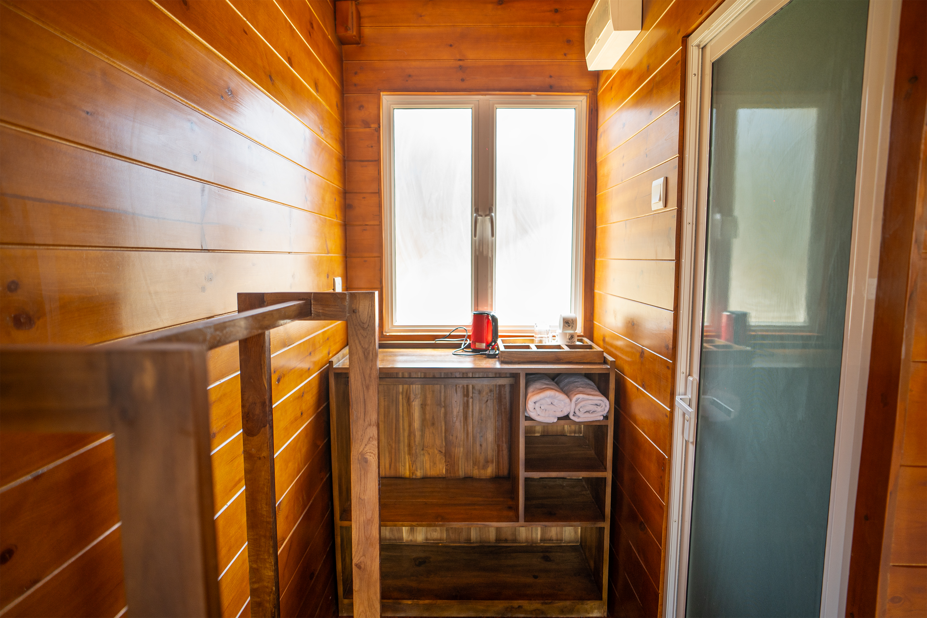 Bedroom with plunge pool visible through glass